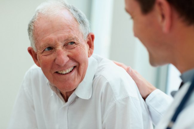 Happy senior citizen having a casual small talk with the friendly doctor