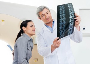 Radiologist And Patient Looking At X-ray