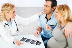 Young family visiting a doctor, looking at Ultrasound.