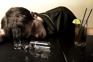 Drunken man passed out at bar